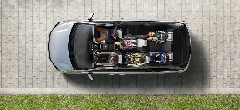 2027 Honda Odyssey Elite in color top on a paved driveway showing the interior seating layout (Minivan).
